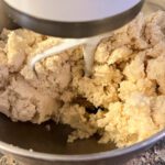 freshly mixed pie dough in a stand mixer