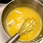 adding butter to lemon curd