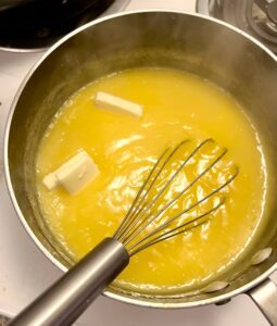 adding butter to lemon curd