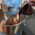 pouring chocolate into whipped eggs