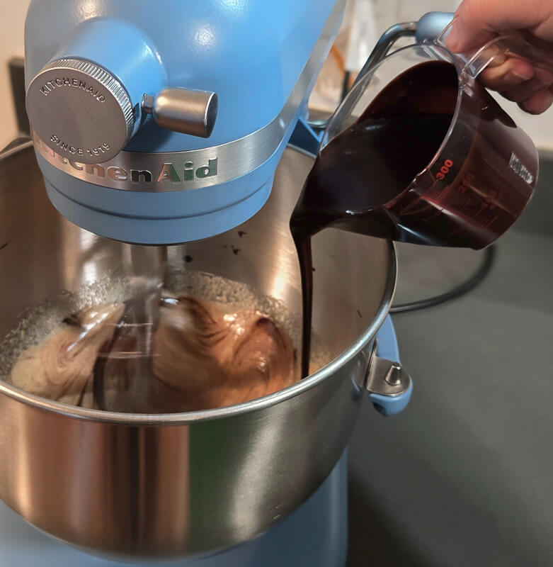 pouring chocolate into whipped eggs
