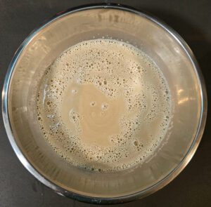 a photo of butterscotch custard after tempering the egg yolks