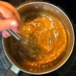 a photo of butterscotch being whisked together on a stovetop