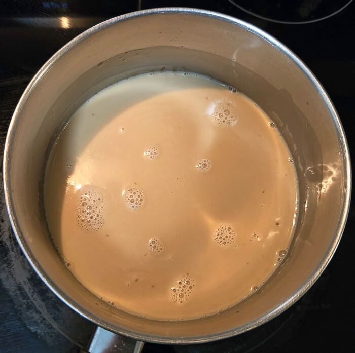 a photo of a pot with milk and butterscotch mixed together