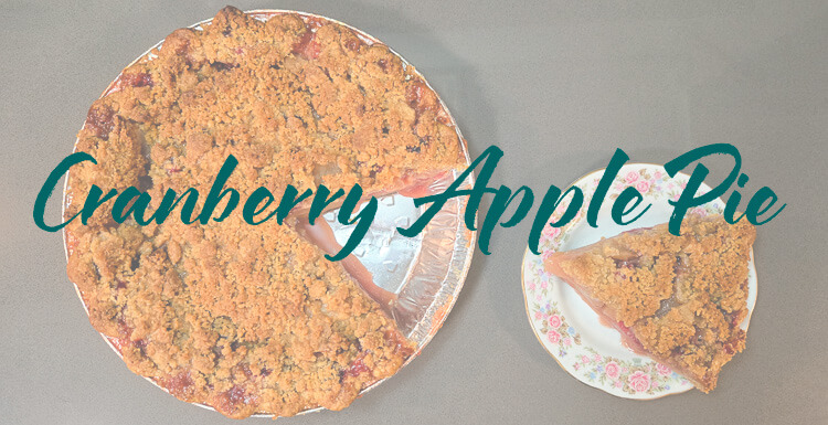header image for cranberry apple pie with a cranberry apple pie with a slice cut out with a text overlay that reads "cranberry apple pie"