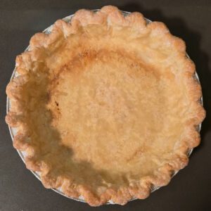 pie crust with cream brushed around edges