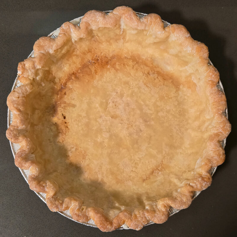 pie crust with cream brushed around edges