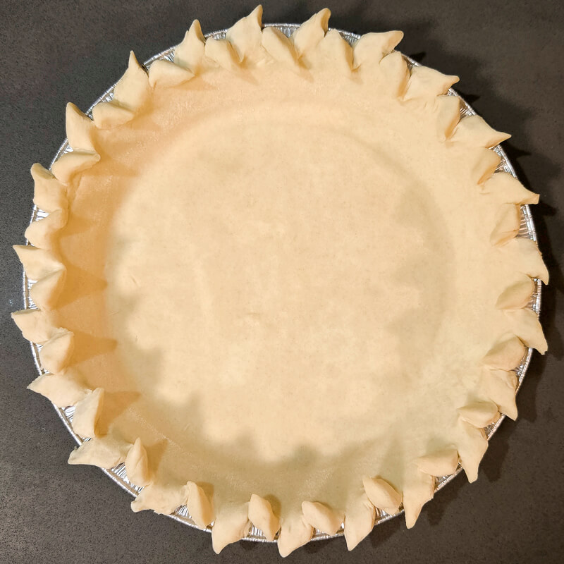 pie crust design made by cutting a rolled edge that looks like a wheat stalk