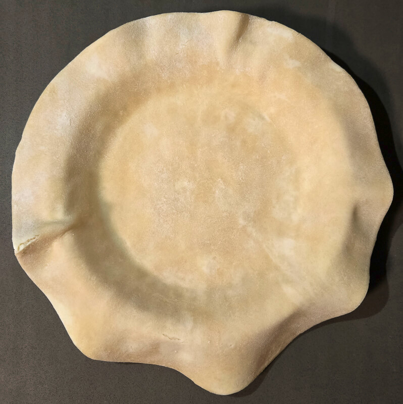 pie dough fitted into a pie tin
