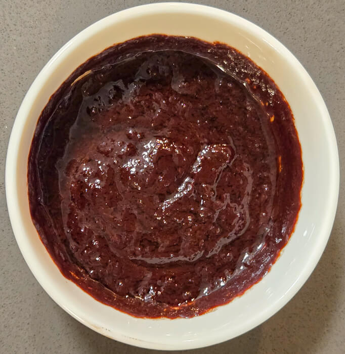 an overhead shot of a broken chocolate ganache caused by heating the cream too much before adding it to the chocolate