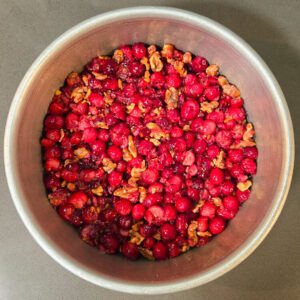 cranberries and walnuts pressed into the bottom of a cake pan