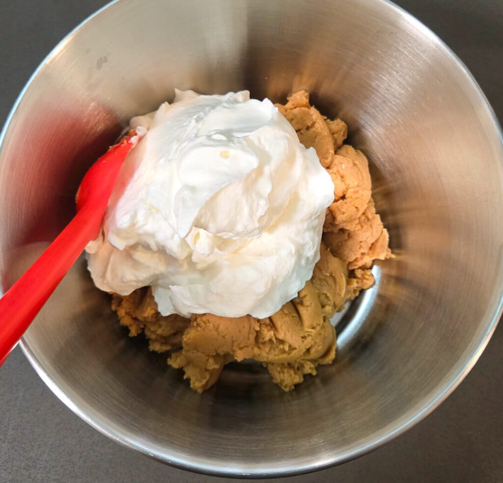 folding whipped cream into a no-bake peanut butter cheesecake filling