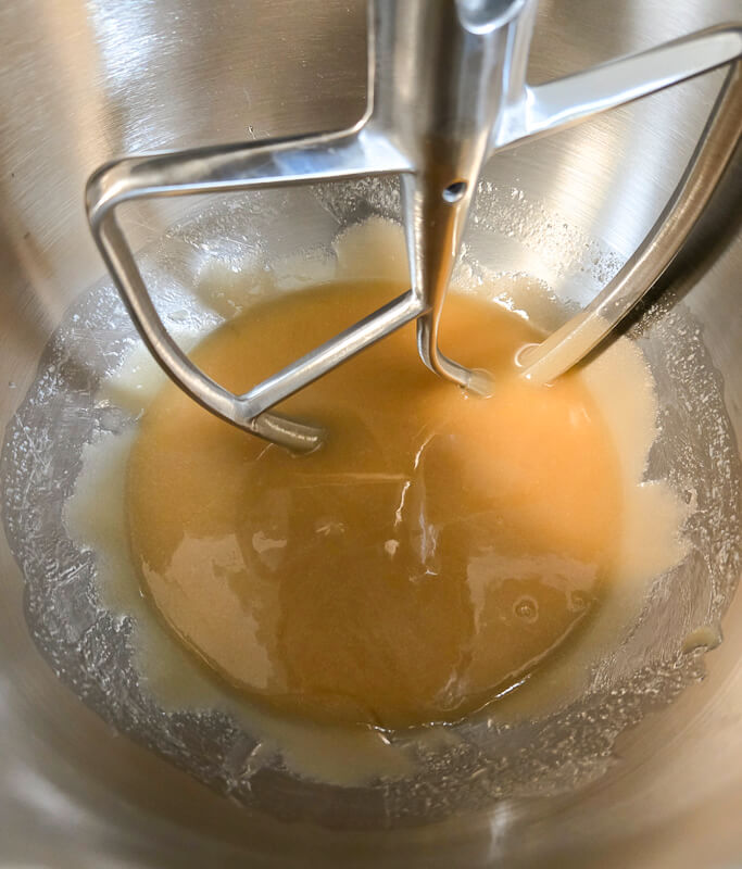 pecan pie filling beginning to be mixed: light and dark corn syrup, sugar, and butter