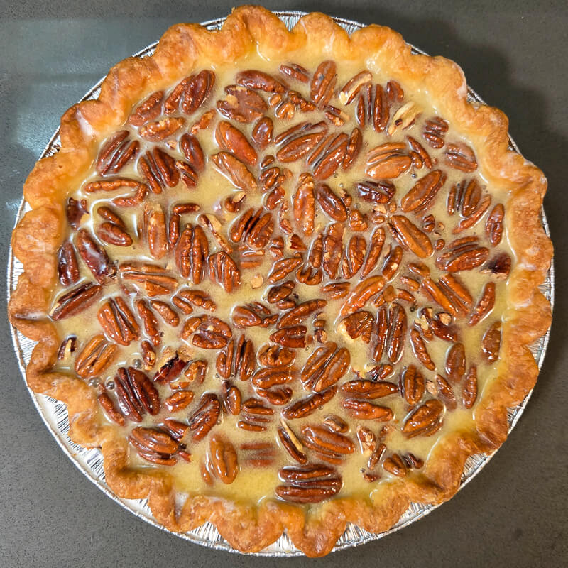 overhead photo of an unbaked pecan pie before it goes in the oven