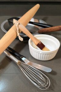 a close up photo of baking tools aesthetically laid out for essential pie making tools
