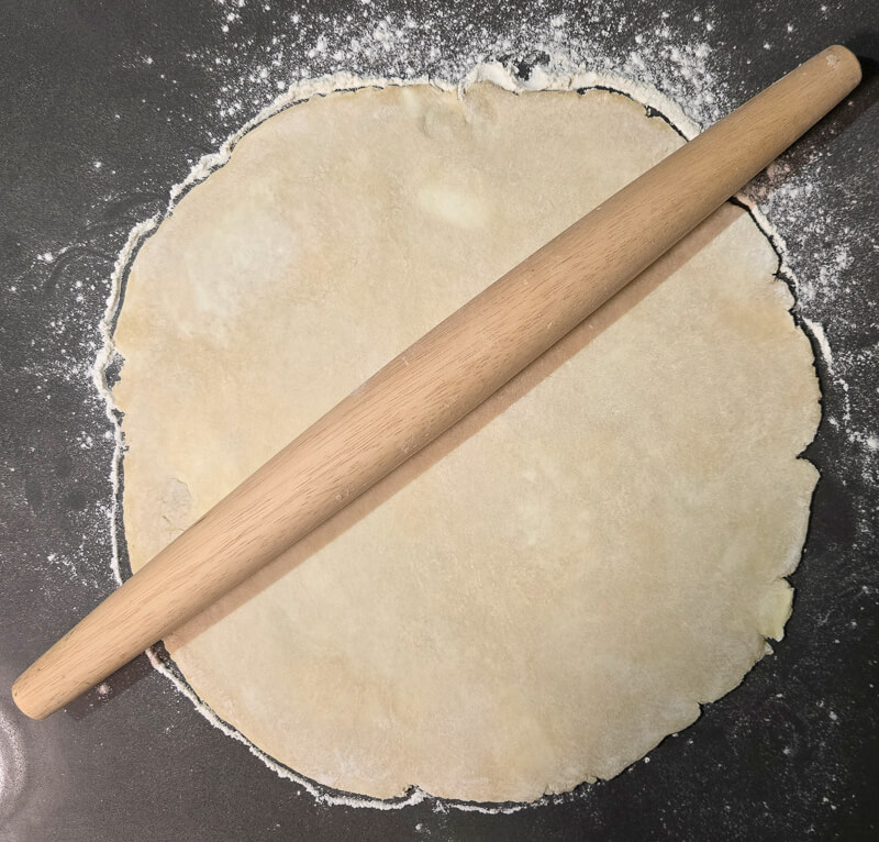 rolling out pie dough with a rolling pin