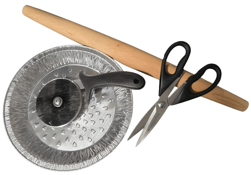 tools for rolling out pie dough: pie tin, pizza cutter, kitchen scissors, rolling pin