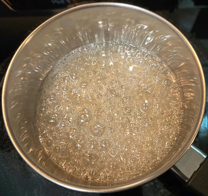 a photo of a pot with boiling sugar