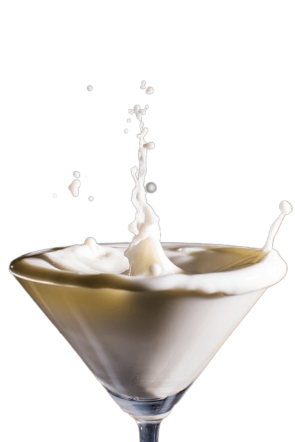 milk splashing into a martini glass on a transparent background