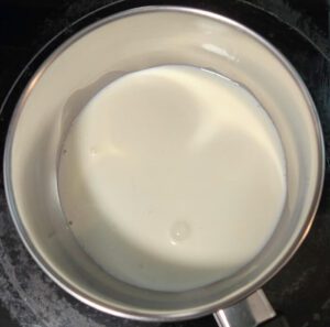 Photo of a pot with cream to be scalded