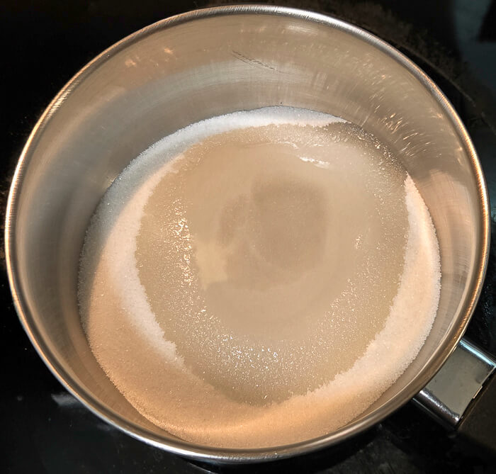 Photo of a pot with sugar and water