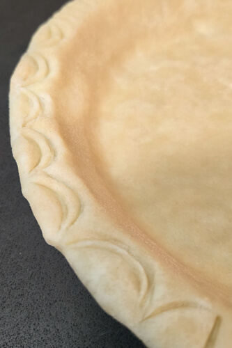 pie crust decorated edge with a spoon