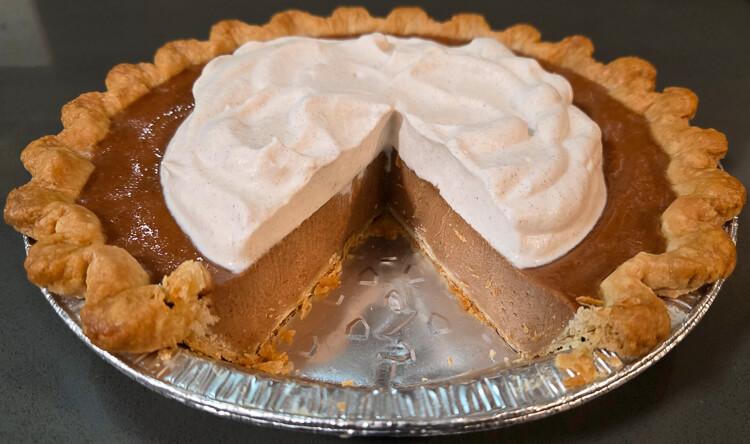 a photo of a cross-section of apple butter pie after a slice has been cut out