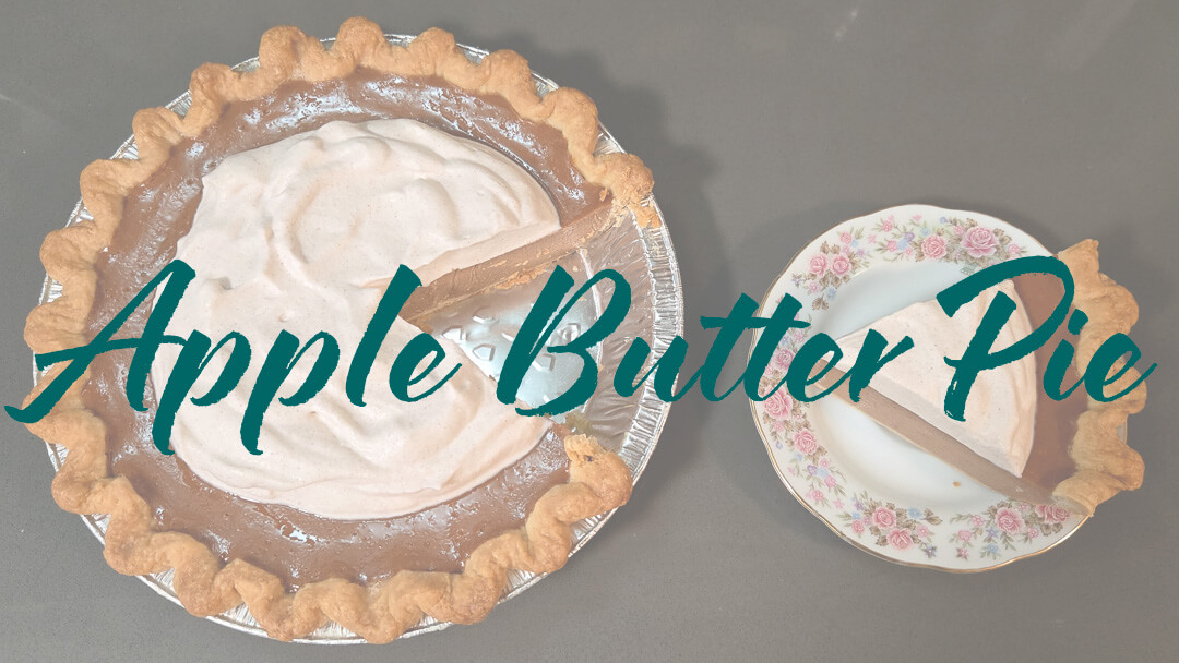 an overhead photo of an apple butter pie with a slice cut out and placed on a floral plate with text overlay that reads "Apple Butter Pie" for Apple Butter Pie Recipe
