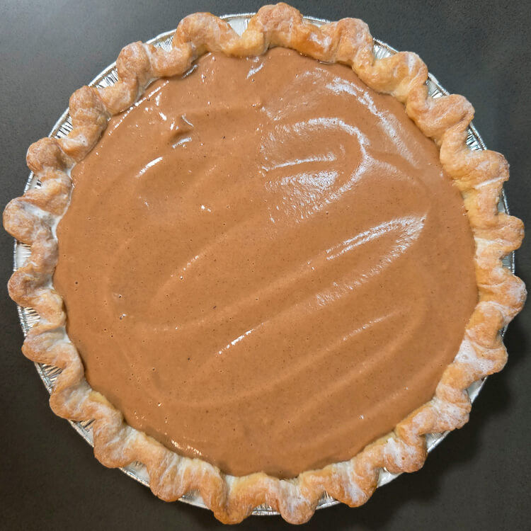 An overhead photo of an apple butter pie before it goes into the oven to be baked