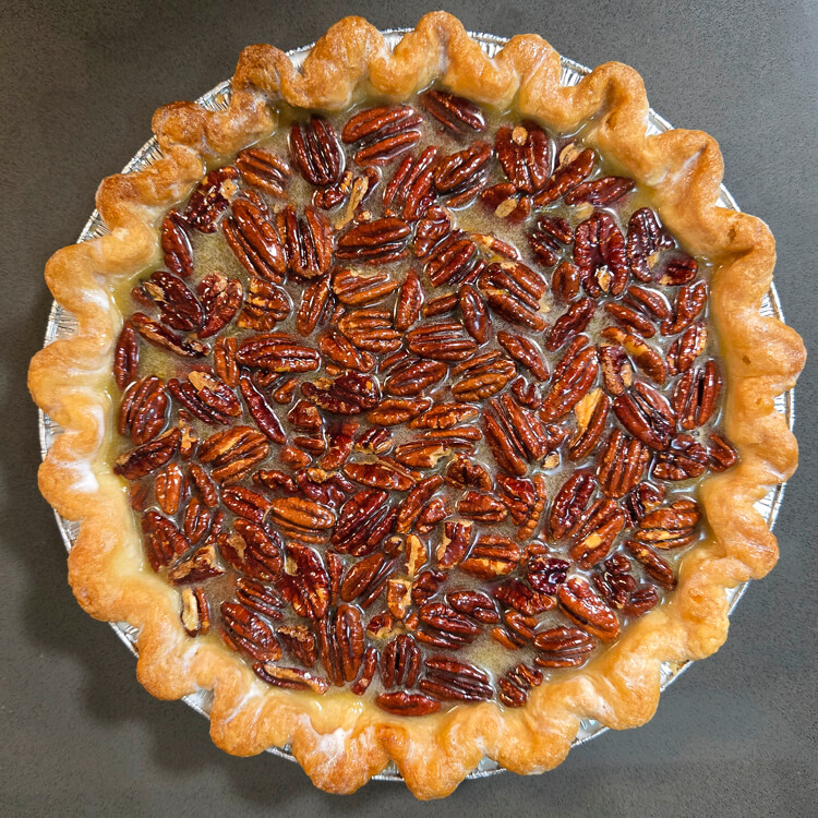 an overhead photo of an unbaked bourbon pecan pie