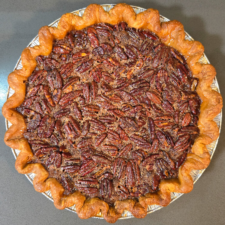 an overhead photo of a baked bourbon pecan pie