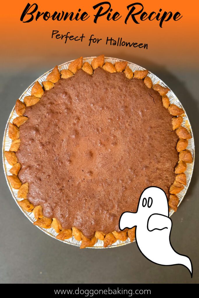 Whole brownie pie with orange gradient background and ghost graphic, labeled “Brownie Pie Recipe Perfect for Halloween,” fall dessert photo.