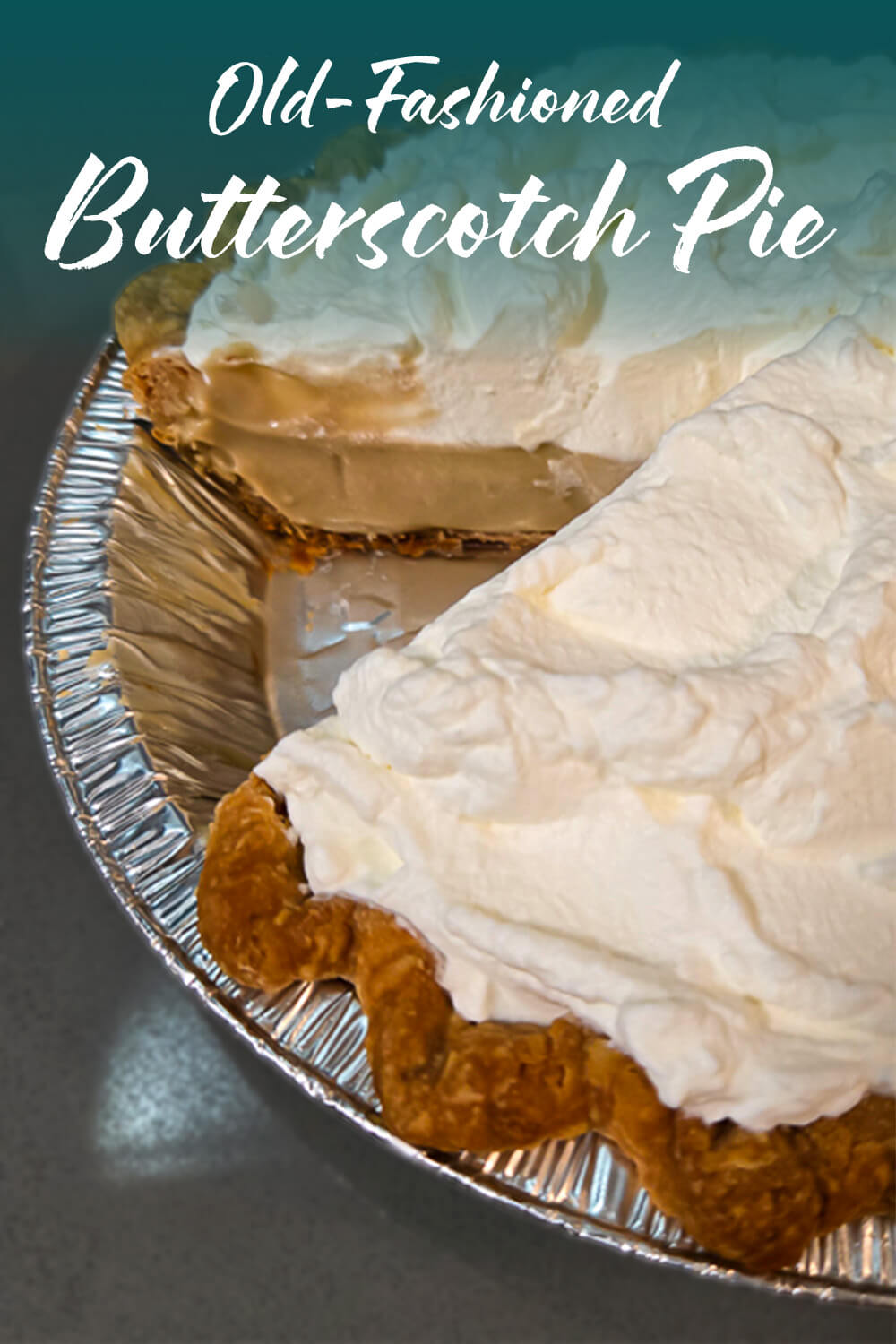 An overhead angle of an old-fashioned butterscotch pie with a slice removed, showing a golden butterscotch pudding filling in a graham cracker crust topped with a thick layer of whipped cream. Text overlay reads Old-Fashioned Butterscotch Pie.