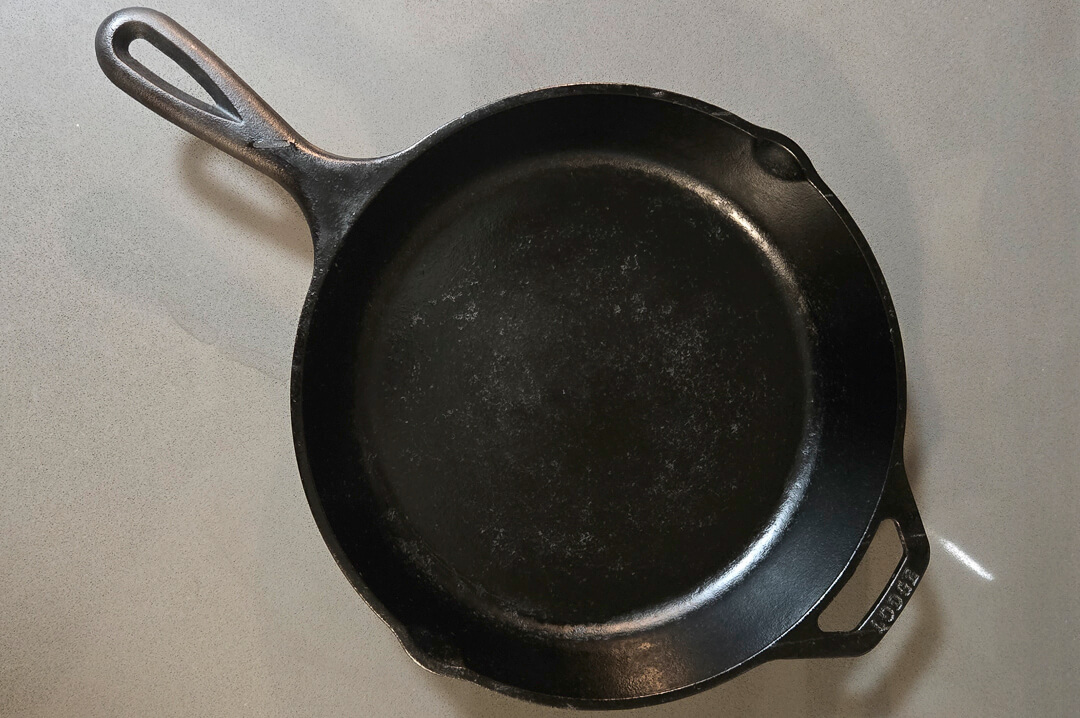 an overhead photo of a well seasoned cast iron skillet