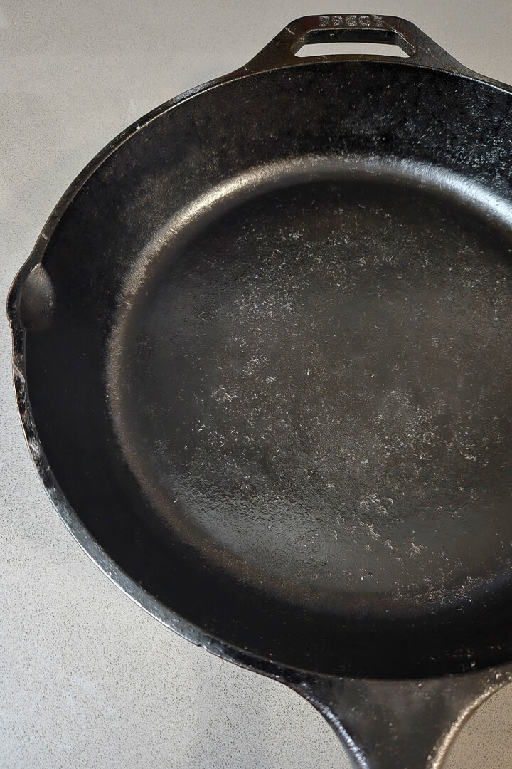 a close up photo of a seasoned cast iron pan