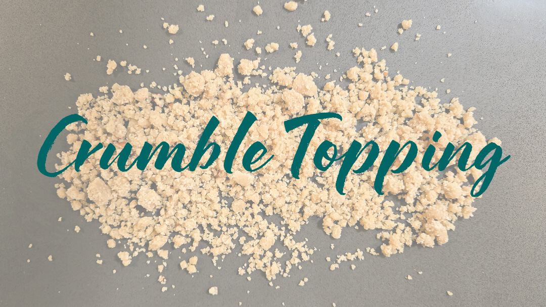 overhead photo of freshly mixed crumble spread over a countertop with text overlay that reads "Crumble Topping"