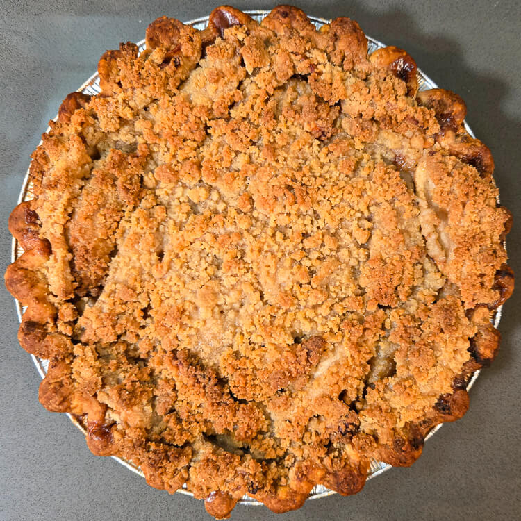 overhead photo of a golden brown baked Dutch apple pie