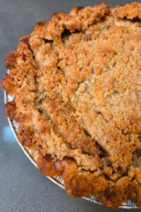 close up photo of a Dutch apple pie with golden brown crumble topping