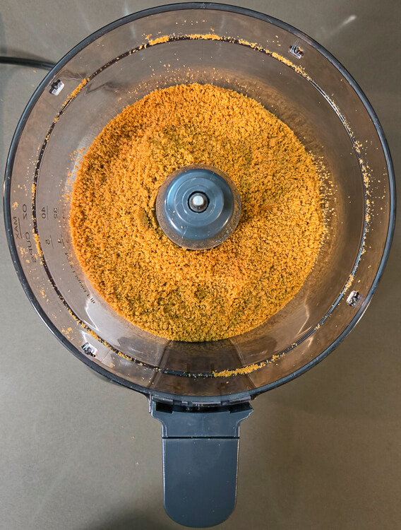 overhead photo of graham cracker crumbs in a food processor