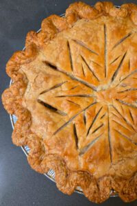 overhead closeup photo of a turkey pot pie with decorative cut outs in the shape of a snowflake