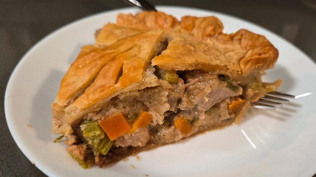 close up photo of a slice of turkey pot pie made with leftover thanksgiving turkey and green bean casserole