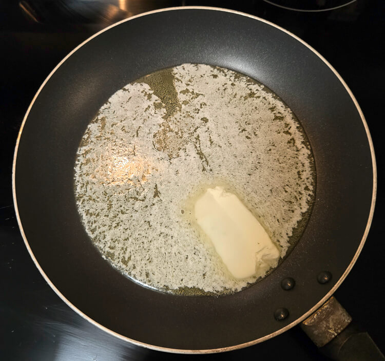 a stick of butter melting in a nonstick pan
