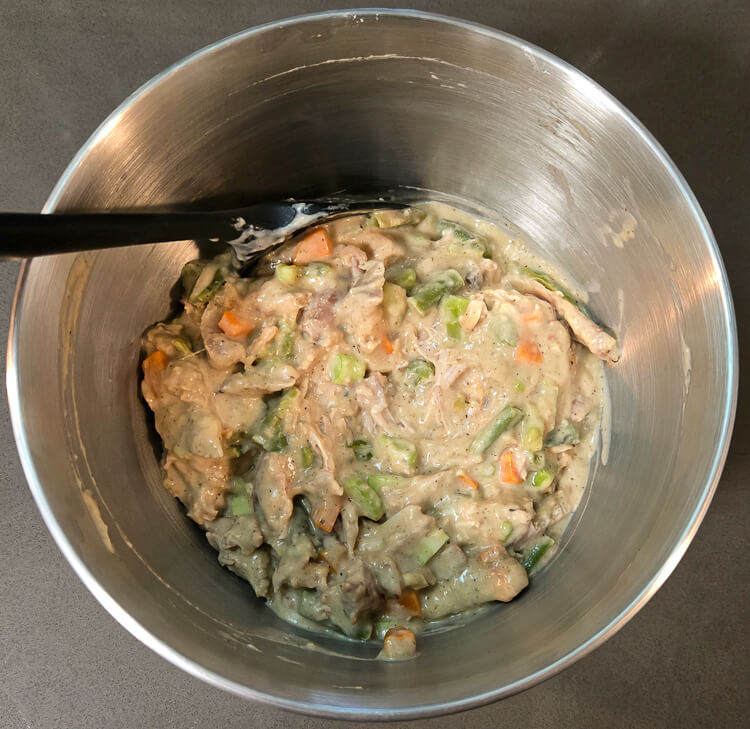 creamy turkey pot pie filling in a mixing bowl after being fully mixed