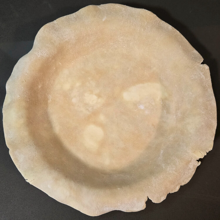 a round of pie dough fitted into a pie tin
