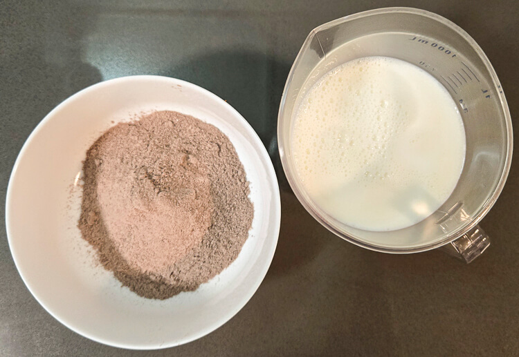 an overhead photo showing instant pudding mix and a pitcher of milk
