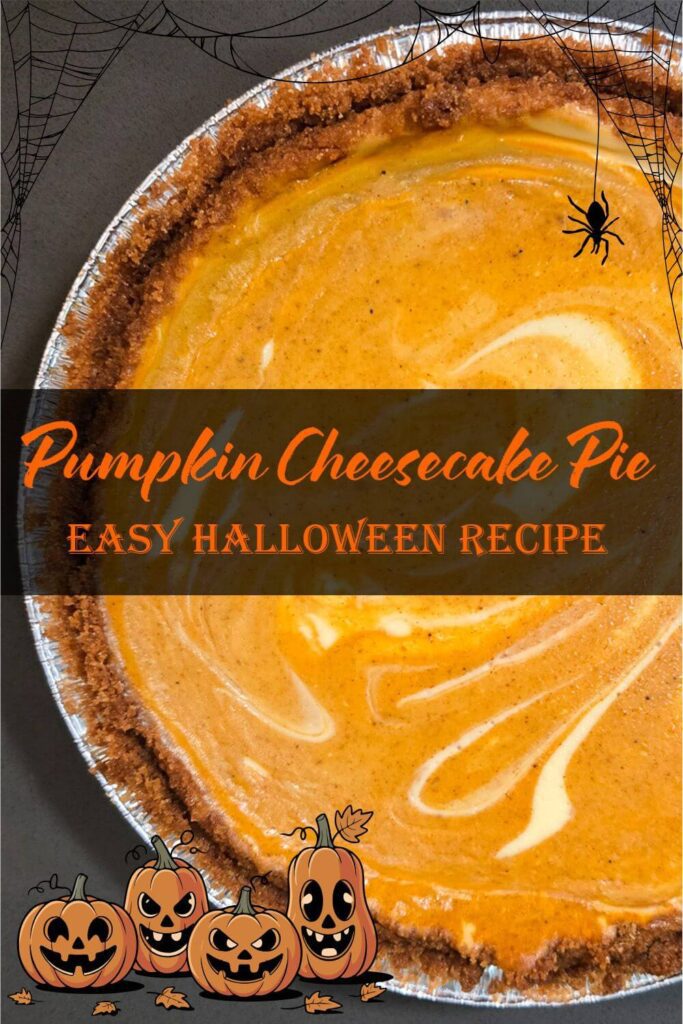 Pumpkin cheesecake pie with swirled orange and cream layers in a graham cracker crust, decorated for a Halloween-themed dessert.