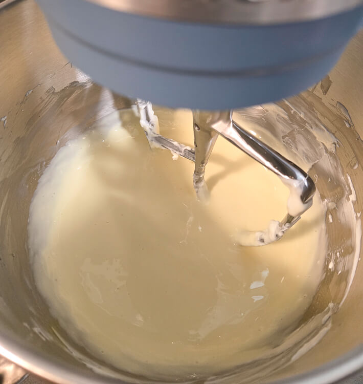 vanilla cheesecake filling in a stand mixer