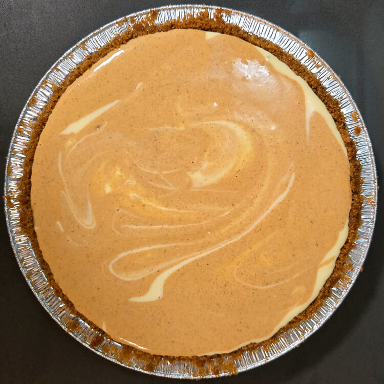 a swirled pumpkin cheesecake pie before being baked