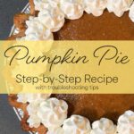 Top view of pumpkin pie with piped whipped cream border and yellow text banner reading “Pumpkin Pie Step-by-Step Recipe with Troubleshooting Tips.”