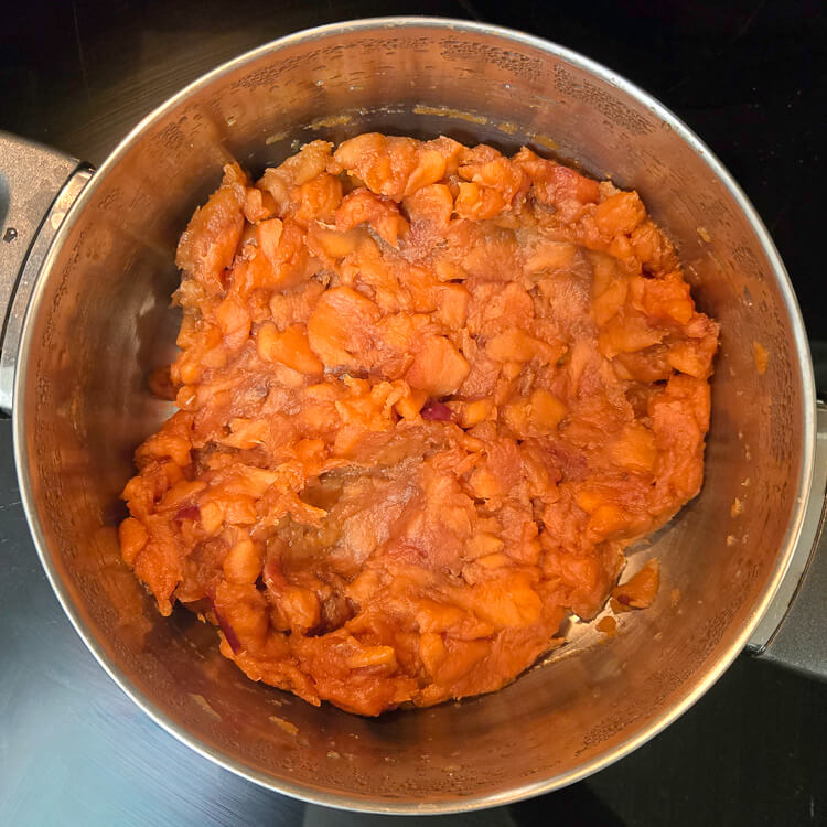 an overhead photo of stewed, rehydrated apples in a mixing bowl